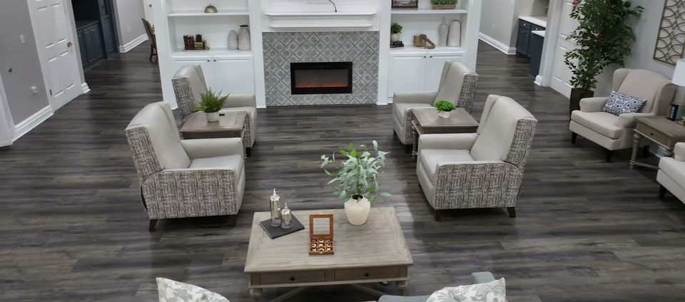 Living room at Silverleaf at Bee Cave with a tiled fireplace and armchairs around a low table