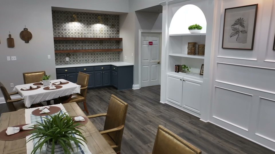 Dining room at Bee Cave with a set table and the blue built in servery and open shelving along the wall