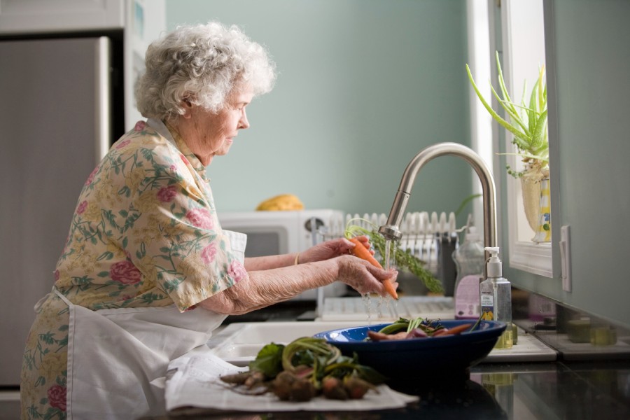elderly woman washing veggies - Austin Assisted Living Homes & Retirement Communities Facilities near and in Austin